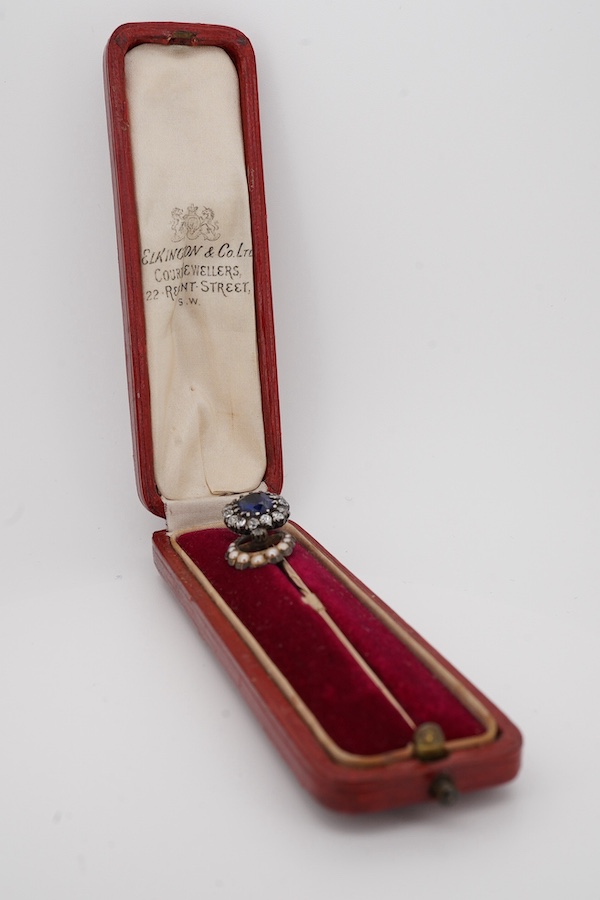 A late Victorian yellow metal, blue paste and diamond cluster set stick pin, 68mm, together with a 15ct, diamond and seed pearl set crescent stick pin. Condition - poor to fair
